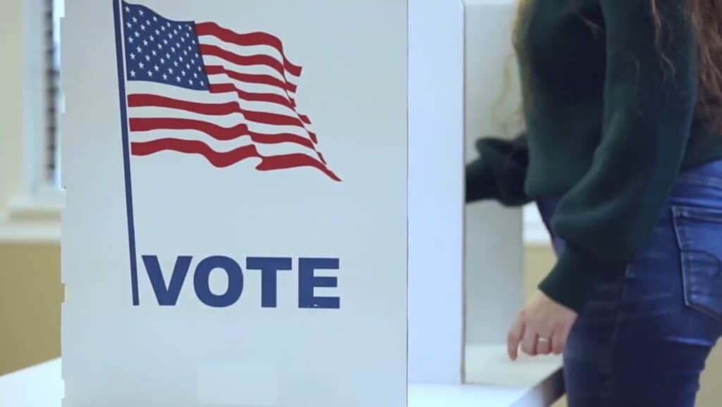 Voter casting ballot at polling station during election day in the United States.